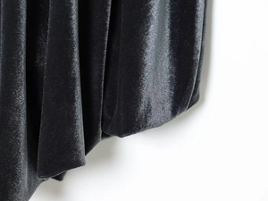 Detailed close-up of premium black velvet fabric showing soft texture and subtle sheen