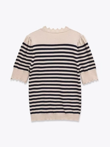 Detail of scalloped edges and black striped knit texture on a white short sleeve top