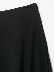 Detail of side invisible zipper on black satin skirt with delicate fabric texture