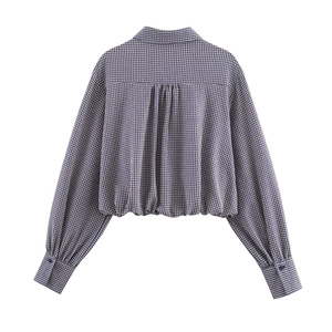 Back view of women's short plaid shirt in blue and white with pleated yoke detail