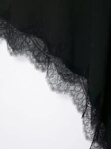 Detailed close-up of the black satin skirt featuring elegant eyelash lace trim and texture