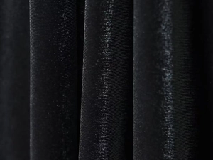 Macro shot of black velvet balloon top fabric with pleated texture and subtle sheen