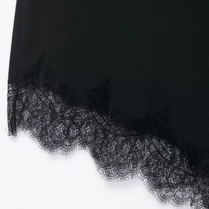 Elegant black satin skirt with intricate eyelash lace trim and refined fabric textures