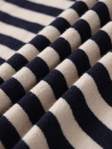 Close-up of navy and cream striped knit fabric showing soft texture and fine stitching