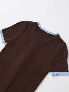 Detail of contrast rib knit texture on dark brown short sleeve top with blue trim