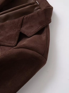 Macro shot of dark brown faux suede jacket collar with detailed stitching and smooth lining