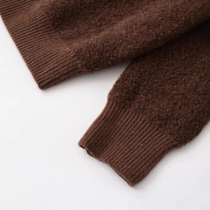 Women's brown bouclé wool bomber jacket showing ribbed cuff details and textured fabric