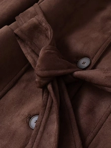 Close-up detail of dark brown faux suede jacket with knotted belt and round buttons