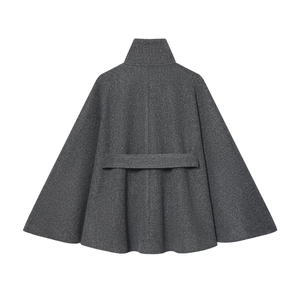 Macro detail of dark grey wool blend cape coat showing premium texture and back strap design