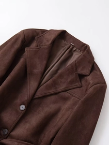 Detailed view of dark brown faux suede jacket with notched lapels and matching buttons