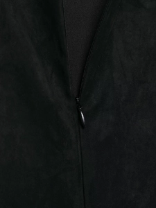 Close-up detail of smooth matte suede fabric and invisible zipper on black dress