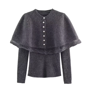 Dark grey knitted poncho cardigan with lace trim and white pearl buttons on white background