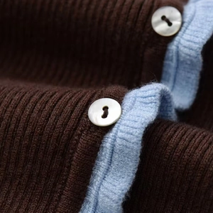 Short sleeve knit jacket in dark brown with blue trim and pearl button detail