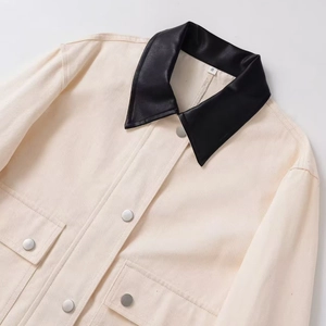Fashionable beige cropped utility jacket with black contrast collar and silver buttons