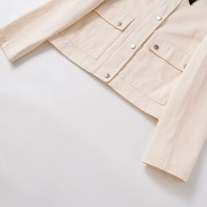 Minimalist off-white cropped workwear jacket with metal buttons and flap chest pockets