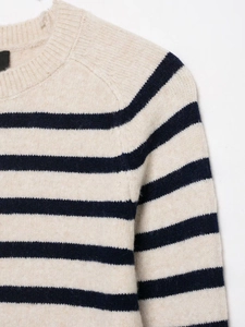 Close-up of the striped knit sweater featuring a ribbed crew neck and soft wool texture