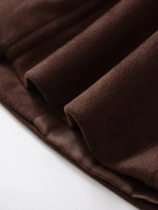 Detail of dark brown faux suede jacket featuring premium satin lining and neat stitching