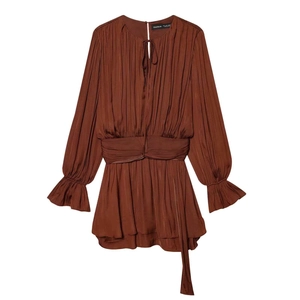 Deep brown pleated long sleeve mini dress with waist tie and ruffle cuffs on white backdrop