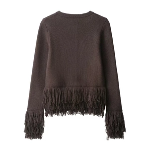 Detail of dark brown knit cardigan featuring long fringe tassels on cuffs and hemline