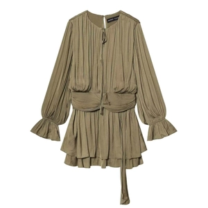 Detail of olive green pleated long sleeve mini dress with waist tie and ruffled hem