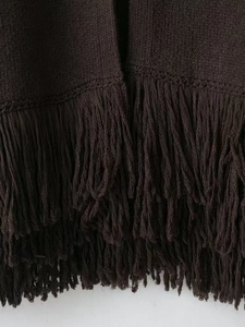 Close-up of ribbed knit texture and long fringe hem details on dark coffee cardigan