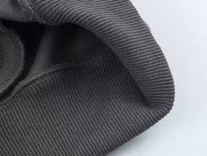 Detailed close-up of charcoal grey ribbed knit cuffs with reinforced stitching