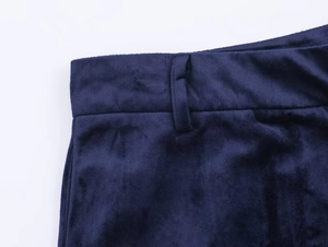 Detailed close-up of the waistband stitching and dark blue velvet fabric texture