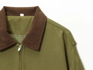 Detail of khaki jacket showing contrast brown corduroy collar and metal zipper