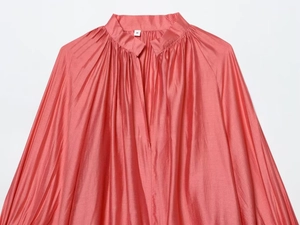 Detail of coral pink satin shirt collar with pleats and V-neck opening and size S label