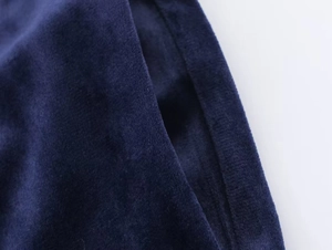 Detailed view of dark blue velvet fabric texture with smooth surface and premium stitching