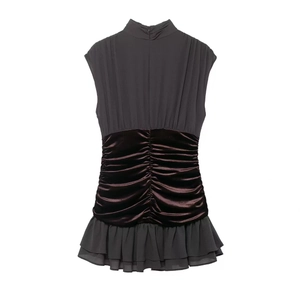 Detail of ruched velvet waist and layered mesh ruffle hem on a slim-fit evening dress