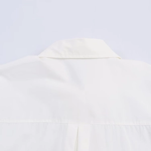 Detailed view of white poplin shirt collar and horizontal shoulder yoke stitching