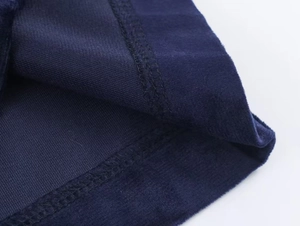 Detail of navy blue velvet fabric showing fine texture and double-needle stitching quality