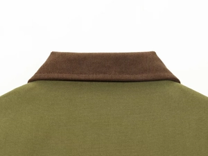 Detail of khaki jacket showing brown corduroy collar and durable canvas fabric texture