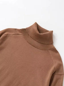 Detail of high neck ribbed knit sweater with dropped shoulders in warm brown fabric