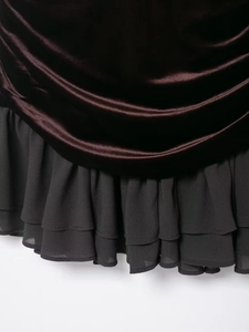 Detail of velvet dress with triple-layered chiffon ruffle hem for an elegant texture