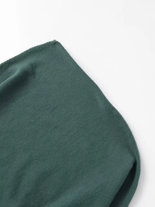 Detailed close-up of dark green knitted fabric texture and fine fiber patterns