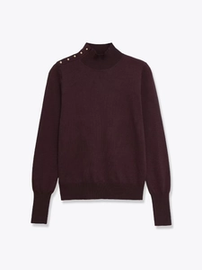 Detail of high mock neck knit sweater with decorative gold buttons on the shoulder