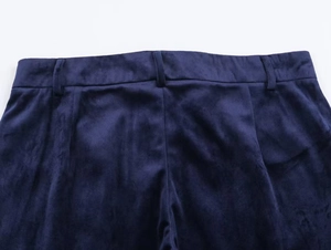 Close-up of dark blue velvet trousers waist with belt loops and vertical pleats