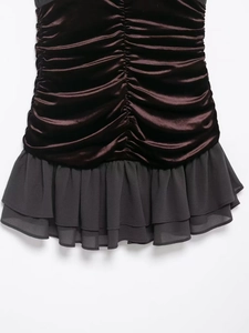 Detail of ruched brown satin hem joined with layered dark grey chiffon ruffles