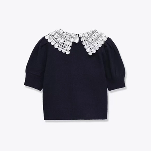 Short knit navy top with an oversized white lace collar and delicate puff sleeves