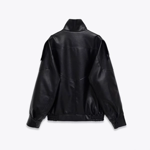 Detail view of black faux leather jacket back featuring classic lychee texture and V-seams
