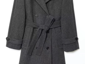 Detail view of dark grey wool blend coat with double-breasted buttons and tied waist belt