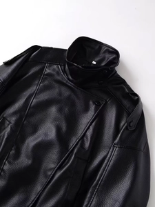 Detail of black pebbled faux leather jacket collar with epaulettes and metallic snaps