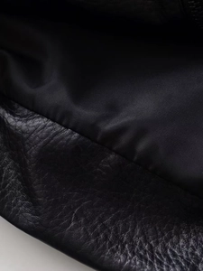 Macro shot of high-quality black lychee texture leather and durable nylon lining detail