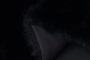Detailed macro view of black faux fur texture with smooth satin lining on a vest
