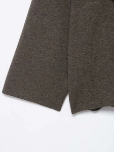 Detailed view of the dark taupe knitted coat cuff showing fine stitching and texture