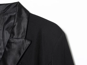 Detail of satin-spliced notched lapel on a black tailored blazer dress for women