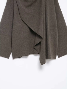 Detailed close-up of brown knit texture and soft wool fabric on a women's cardigan