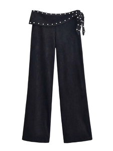 Detailed view of high waist wide leg pants with silver studs and tie-up belt side